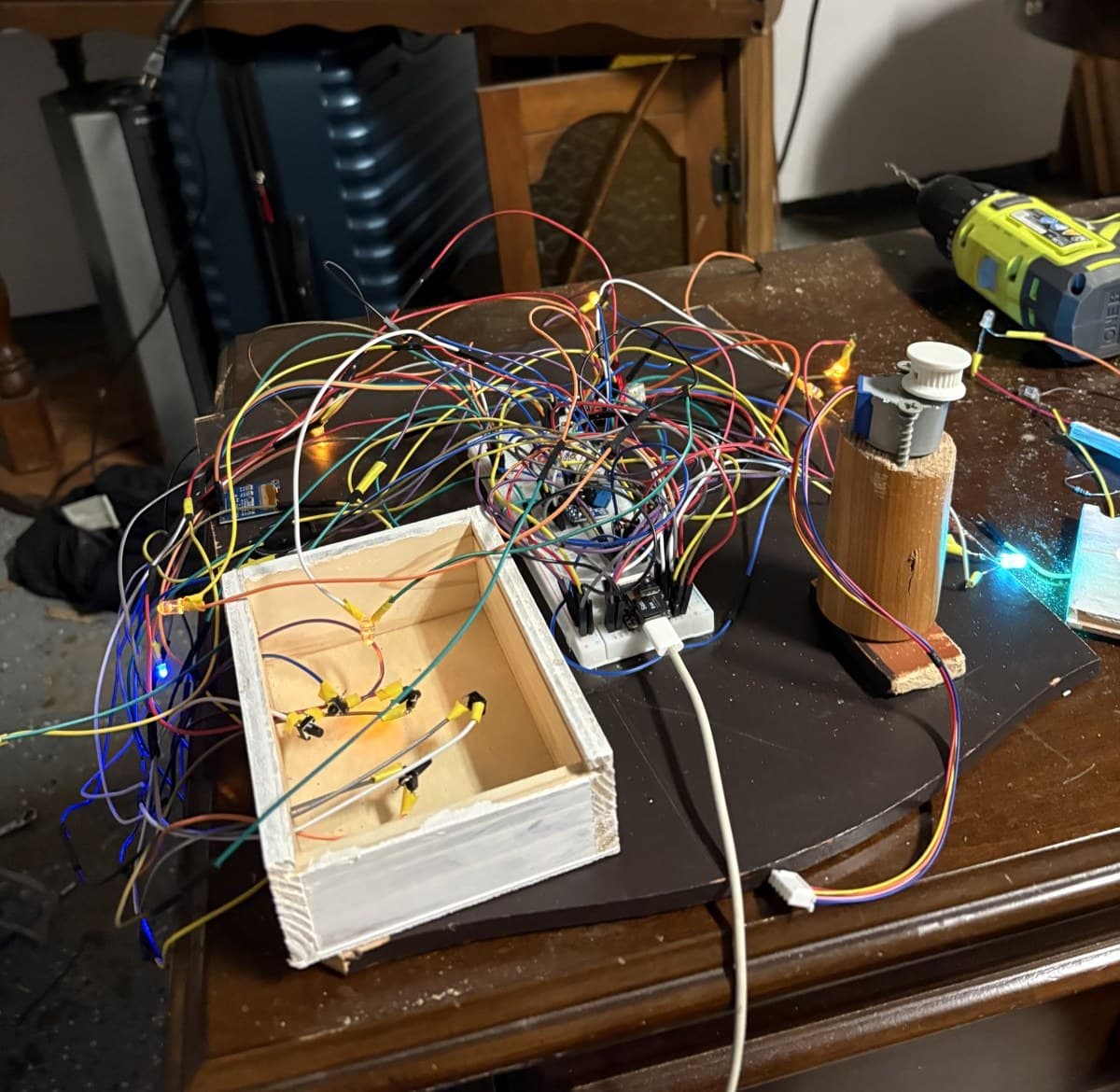 Bench bring-up of the maquette electronics with controller, LED channels, buttons, and stepper tower wired for testing