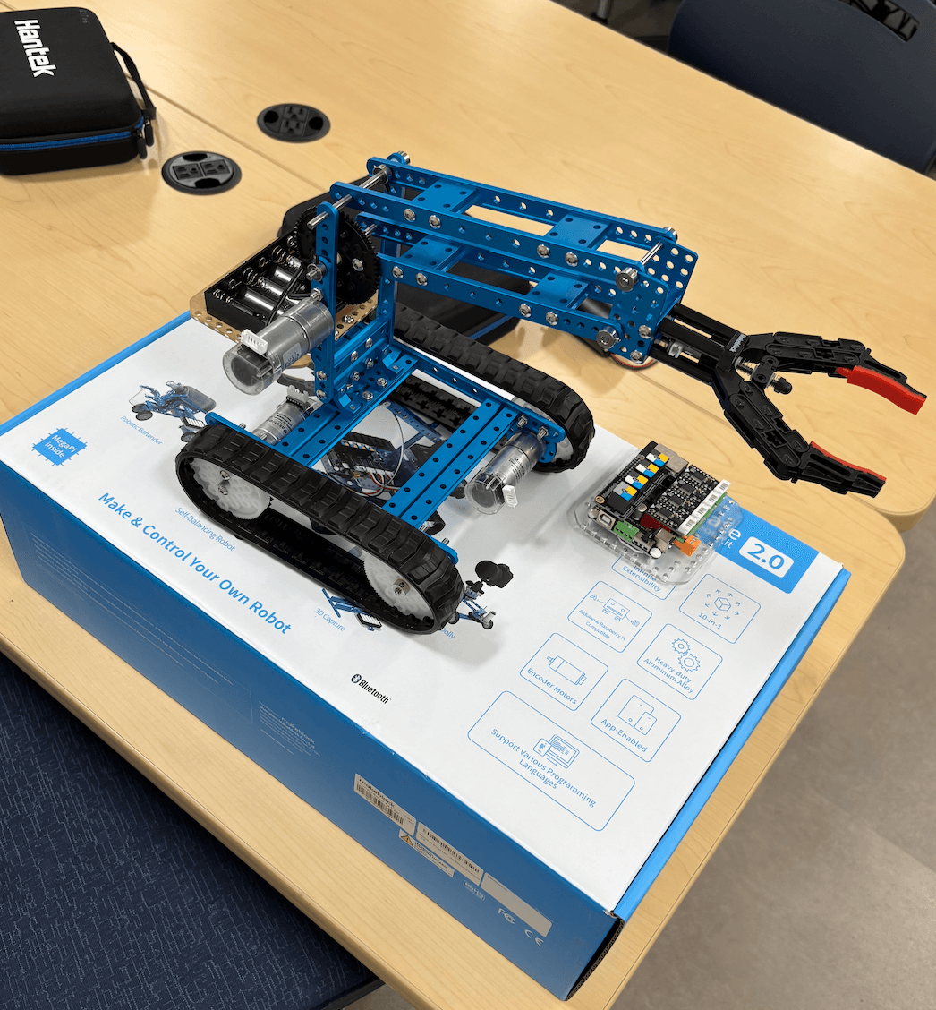 Mobile manipulator robot photographed on its electronics kit box